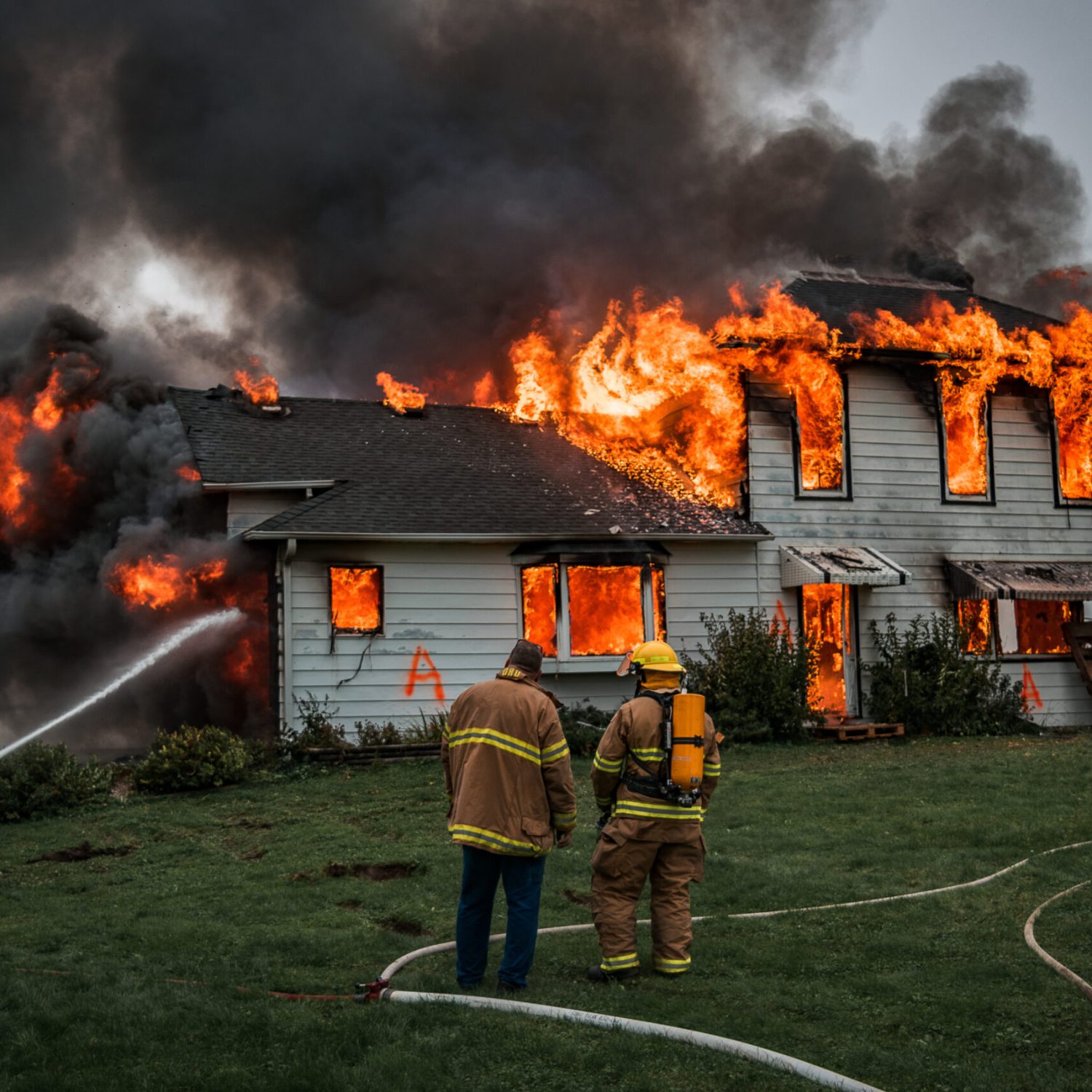 Fire Fighters Putting Out A House Fire